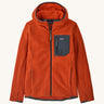 Patagonia kids full zip hoodie in a orange colour on a cream background