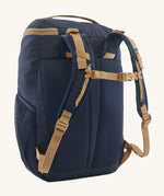 The back of the Patagonia Kids Refugito Day Pack Backpack 18L in a New Navy colour on a plain background. 