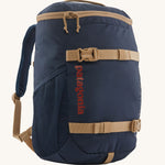 The Patagonia Kids Refugito Day Pack Backpack 18L in a New Navy colour on a plain background. 