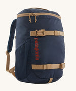 The Patagonia Kids Refugito Day Pack Backpack 18L in a New Navy colour on a plain background. 