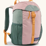Patagonia 12 litre kids refugito day pack backpack in fuzzy mauve pink. Covered drawstring main compartment with  mesh pocket bottle holders on the sides.
