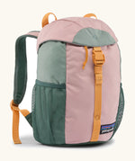 Patagonia 12 litre kids refugito day pack backpack in fuzzy mauve pink. Covered drawstring main compartment with  mesh pocket bottle holders on the sides.