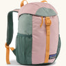 Patagonia 12 litre kids refugito day pack backpack in fuzzy mauve pink. Covered drawstring main compartment with  mesh pocket bottle holders on the sides.