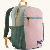 Patagonia 15 litre kids refugito day pack backpack in fuzzy mauve pink. Zipped main compartment with zipped front pocket and two mesh side pocket bottle holders on the sides. 