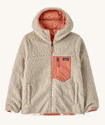 Patagonia Kids Reversible Ready Freddy Hoody in the Moment Pink colour way. The kids coat is shown with the off white, cream coloured high pile fleece on the outside.  We're proud stockists of Patagonia here at Babipur.