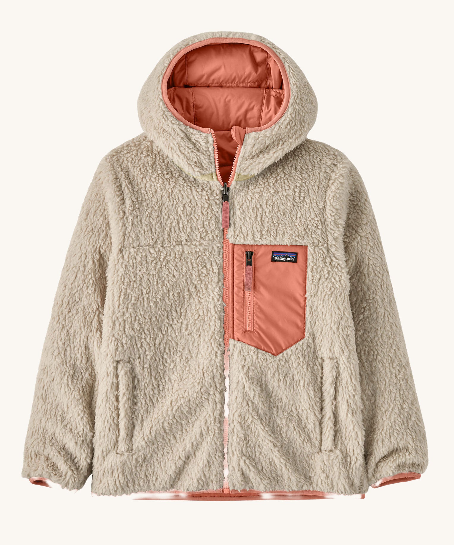 Patagonia Kids Reversible Ready Freddy Hoody in the Moment Pink colour way. The kids coat is shown with the off white, cream coloured high pile fleece on the outside.  We're proud stockists of Patagonia here at Babipur.