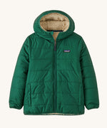 Patagonia Kids Reversible Ready Freddy Hoody in a Conifer Green showing the water resistant fleece side on the jacket on a plain background.