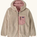 Patagonia kids reversible ready freddy hoody water resistant jacket in fuzzy mauve shown on cream fleece side with pink chest pocket.