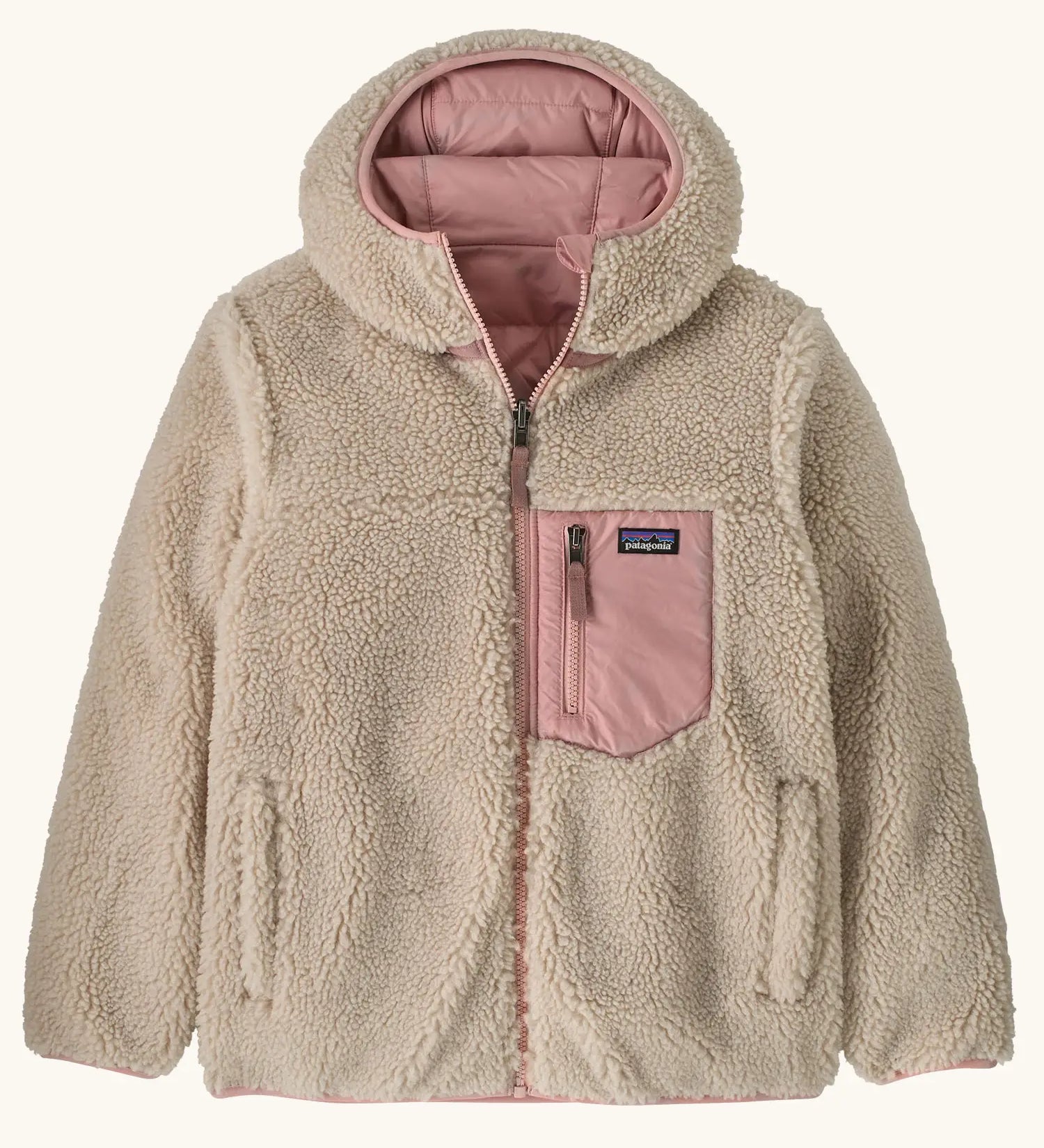 Patagonia kids reversible ready freddy hoody water resistant jacket in fuzzy mauve shown on cream fleece side with pink chest pocket.