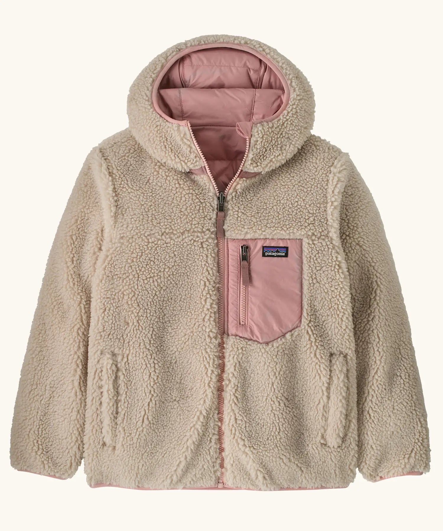 Patagonia kids reversible ready freddy hoody water resistant jacket in fuzzy mauve shown on cream fleece side with pink chest pocket.