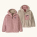 Patagonia kids reversible ready freddy hoody water resistant jacket in fuzzy mauve. Shown on both sides, pink fuzz mauve and cream fleece side with pink zipped chest pocket.