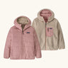 Patagonia kids reversible ready freddy hoody water resistant jacket in fuzzy mauve. Shown on both sides, pink fuzz mauve and cream fleece side with pink zipped chest pocket.