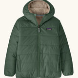 Patagonia kids reversible ready freddy hoody in canopy green on the green side with two side pockets.