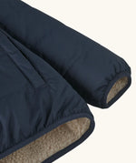 Close up of Patagonia kids reversible ready freddy hoody water resistant jacket in new navy sleeve.