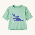 Patagonia kids light green short sleeve t-short caterpillar design on a cream background.