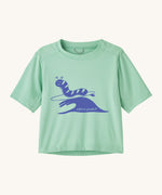 Patagonia kids light green short sleeve t-short caterpillar design on a cream background.