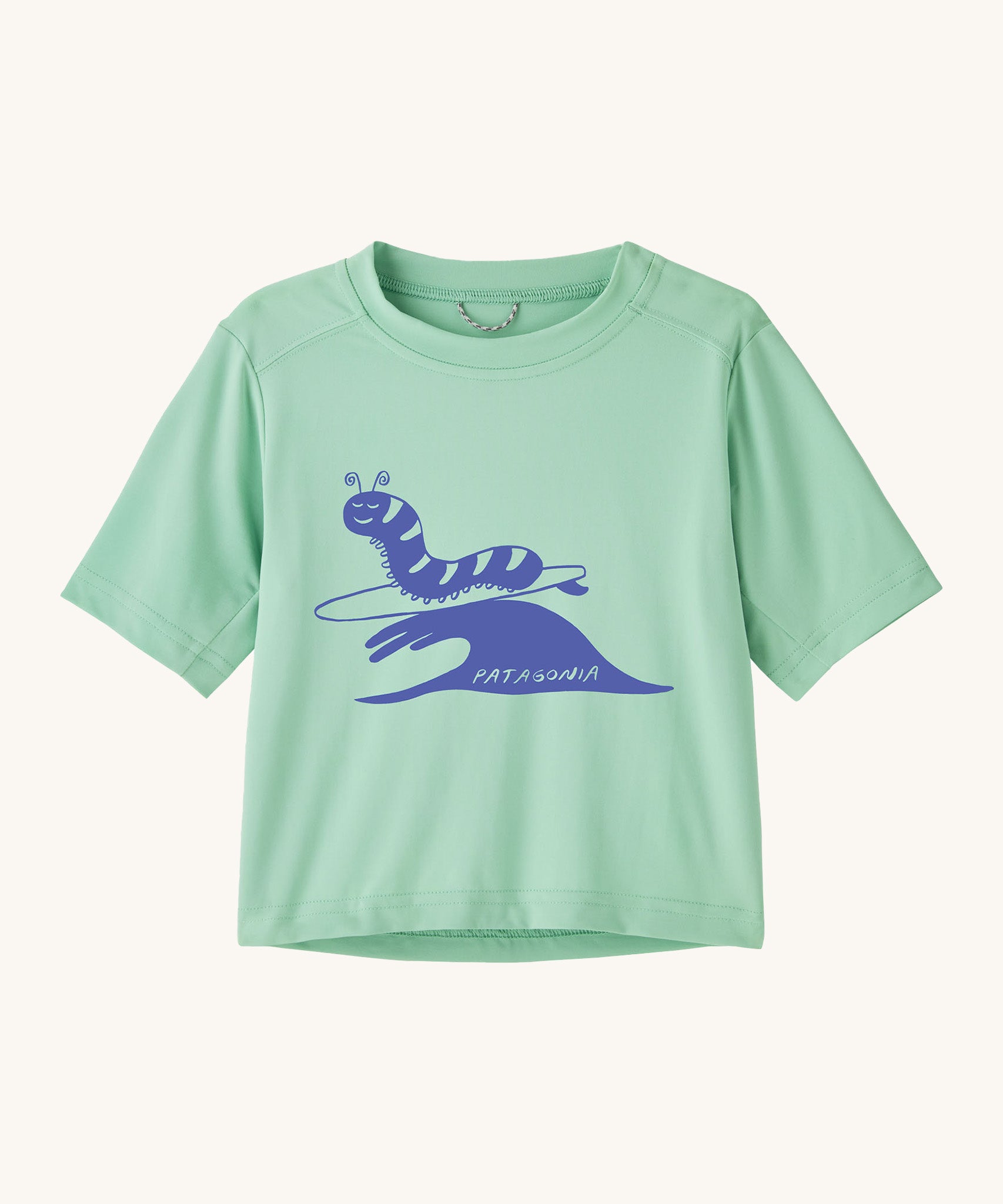 Patagonia kids light green short sleeve t-short caterpillar design on a cream background.