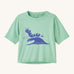 Patagonia kids light green short sleeve t-short caterpillar design on a cream background.