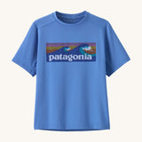 Patagonia kids short sleeve cap tshirt in a light blue colour with logo on a cream background.
