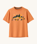 Patagonia kids short sleeve cap tshirt in a peach colour with logo on a cream background.