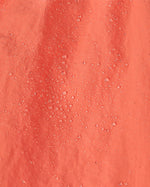 A close up of water droplets on the  surface of the material of a pair of Patagonia Kids Costa Rica Baggies Shorts.