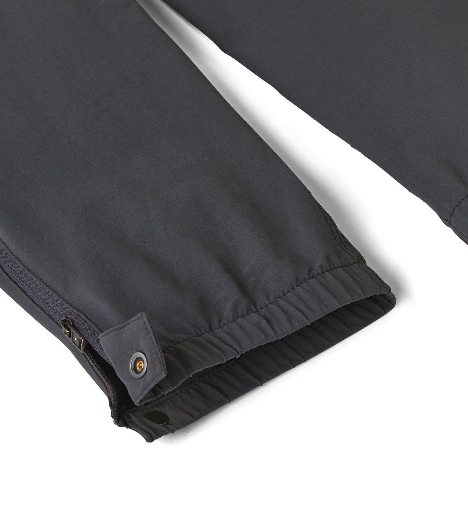 Close up of the elasticated cuff of the Patagonia kids quandry pants. Showing the popper fastener and zip detail for full leg closure.