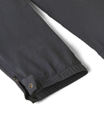 Close up of the elasticated cuff of the Patagonia kids quandry pants. Showing the popper fastener and zip detail for full leg closure.