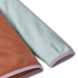 Patagonia kids fleece in Sienna clay showing close up of lilac cuff and hem trim