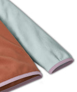 Patagonia kids fleece in Sienna clay showing close up of lilac cuff and hem trim