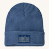 Patagonia kids beanie. A ribbed style hat in blue with the pastel yellow pencil style logo patch stitched on the turned up brim.