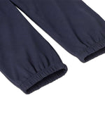 A close up of the cuffs on the legs of the Patagonia Kids Sweatpants in a Fitz Roy Icon New Navy colour way.