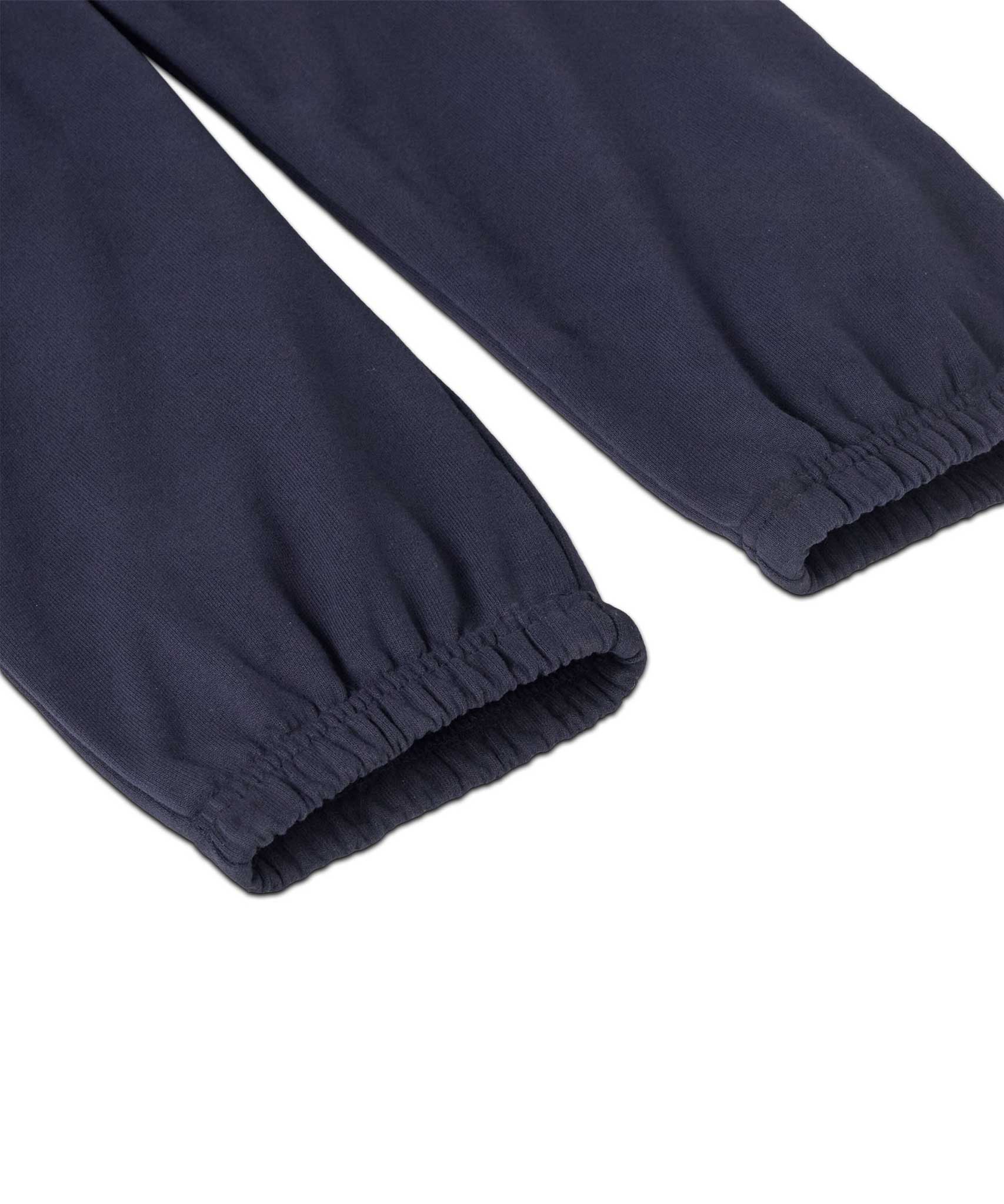 A close up of the cuffs on the legs of the Patagonia Kids Sweatpants in a Fitz Roy Icon New Navy colour way.