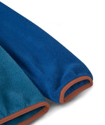 A close up of a Patagonia kids synchilla fleece showing the soft elasticated cuff detail.