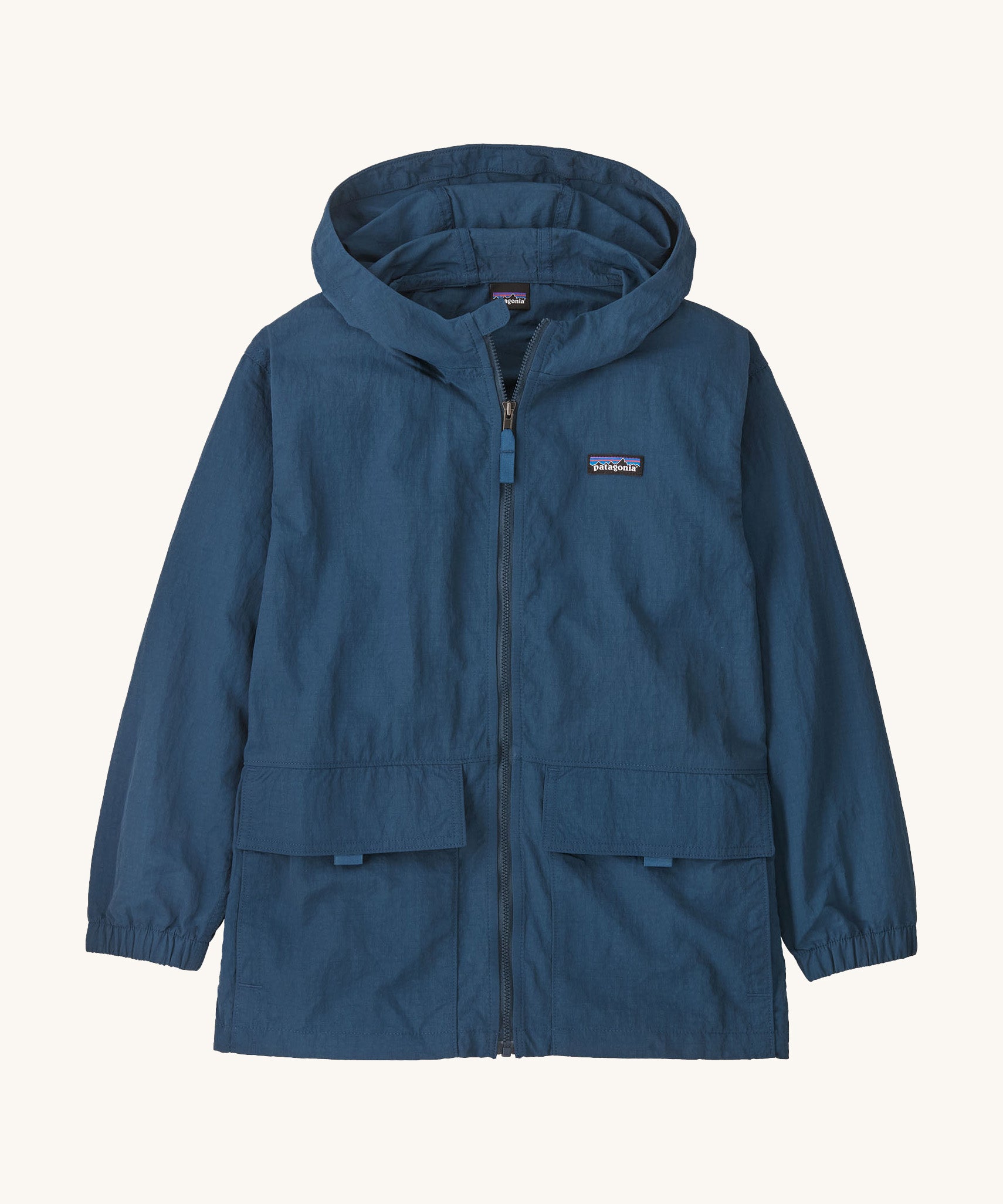 Patagonia kids outdoor everyday jacket in a dark blue colour on a cream background.
