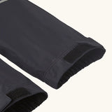 Close up of velcro on the elasticated cuffs of the Patagonia kids waterproof torrentshell 3L rain pants in black.
