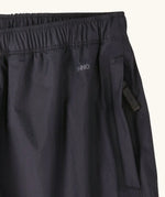 Close up of the zipped hand warmer side pocket on the Patagonia kids waterproof torrentshell 3L rain pants in black.