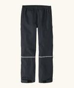 Back of the Patagonia kids waterproof torrentshell 3L rain pants in black. Reflective band around the shins.