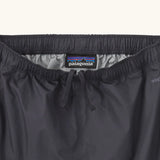 Close up of elasticated waist with inside ties on the Patagonia kids waterproof torrentshell 3L rain pants in black.