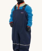 A close up of a mannequin wearing the Patagonia Little Kids Torrentshell 3L Rain Bibs in a New Navy colour.