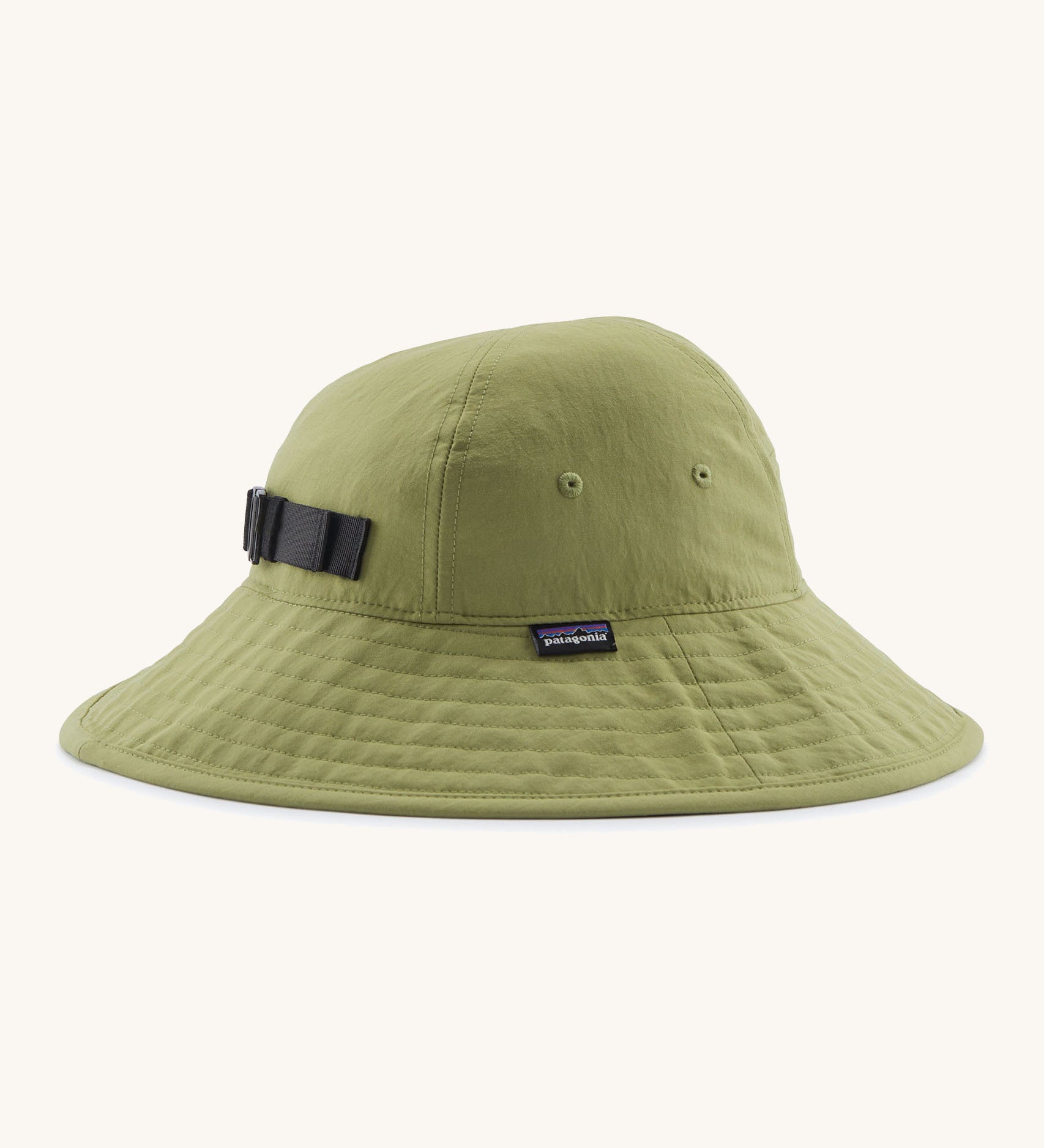 The Patagonia Kid's Trim Brim Sun Hat in green. Showing air holes on the side panel and elasticated size adjust strap