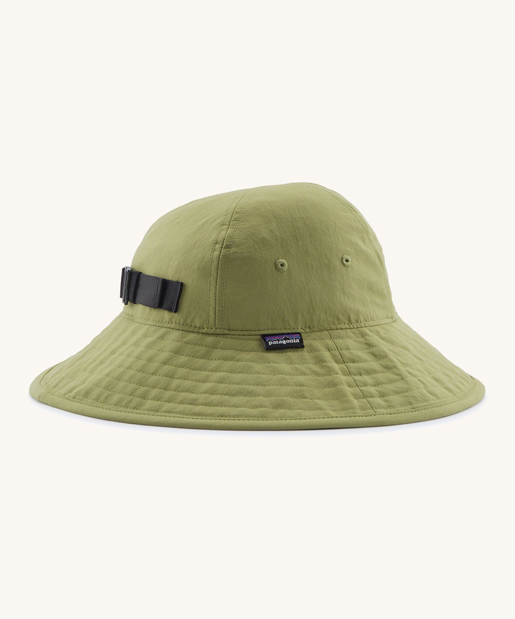 The Patagonia Kid's Trim Brim Sun Hat in green. Showing air holes on the side panel and elasticated size adjust strap