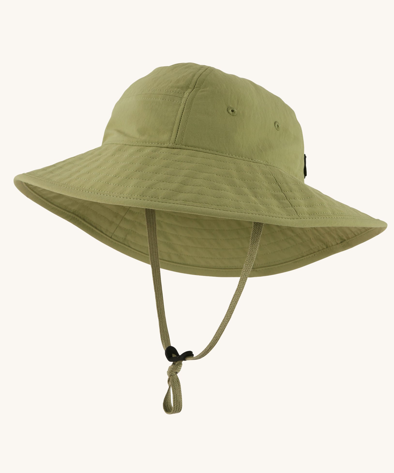 The Patagonia Kid's Trim Brim Sun Hat in green. Showing air holes on the side panel and adjustable chin strap
