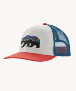 Patagonia kid's trucker hat in birch white with a fitz roy bear on the front, red visor and a navy netting on the back. 