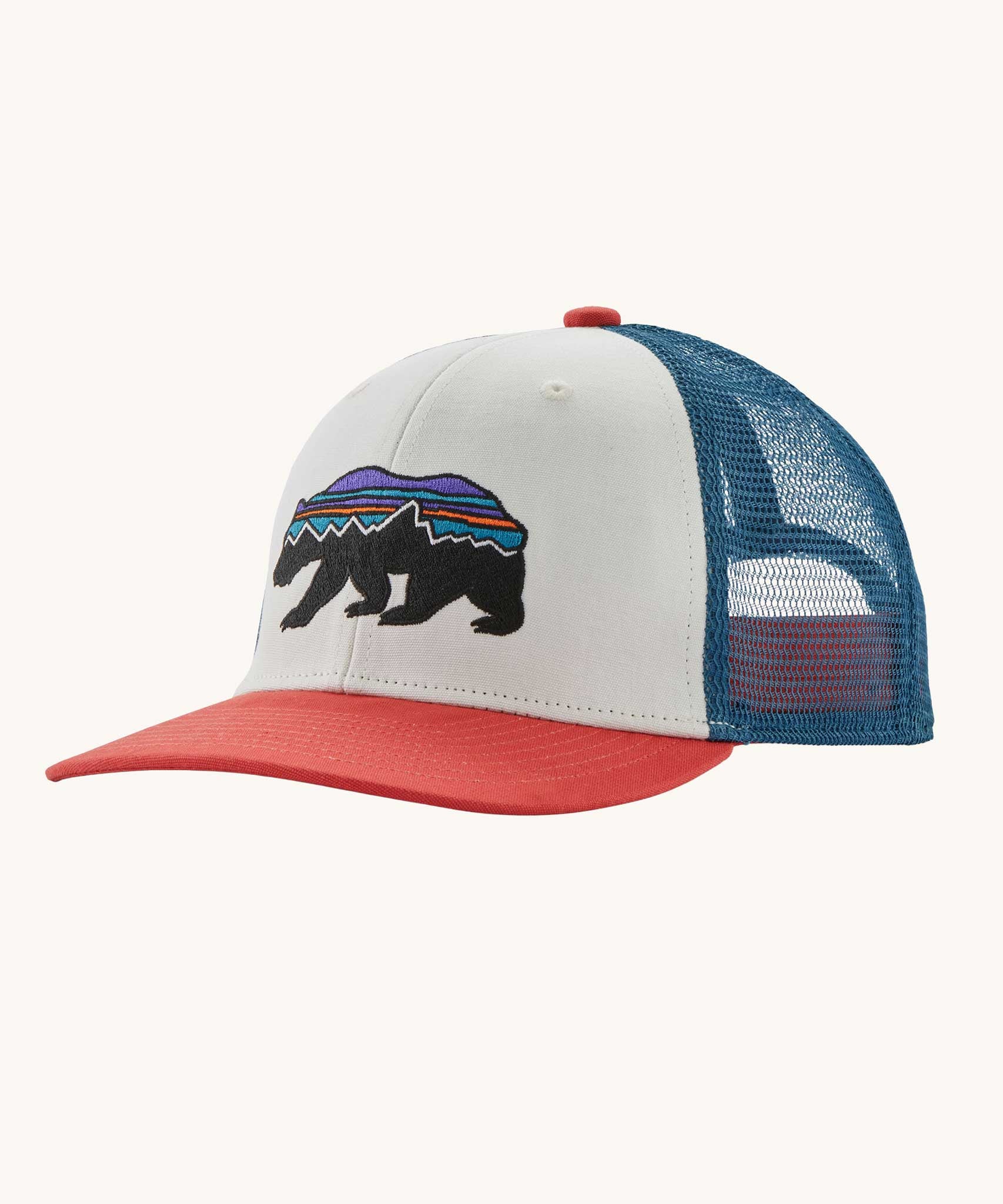 Patagonia kid's trucker hat in birch white with a fitz roy bear on the front, red visor and a navy netting on the back. 