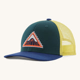 Patagonia kids trucker hat in driftways patch/cascade green. Showing the dark green green front panel, pastel yellow mesh on the back and a dark blue bill. Features a brand patch on the front panel in a shape of a triangle