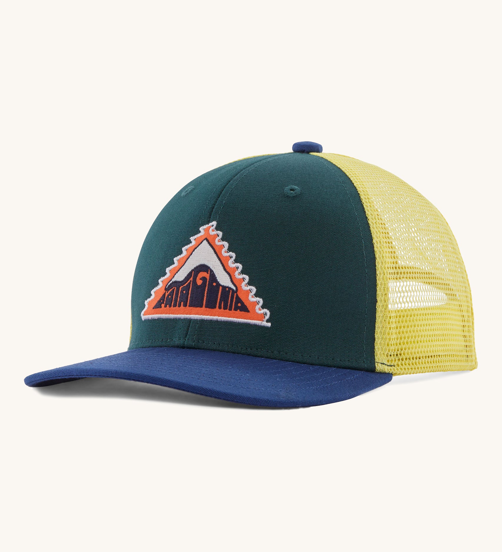 Patagonia kids trucker hat in driftways patch/cascade green. Showing the dark green green front panel, pastel yellow mesh on the back and a dark blue bill. Features a brand patch on the front panel in a shape of a triangle