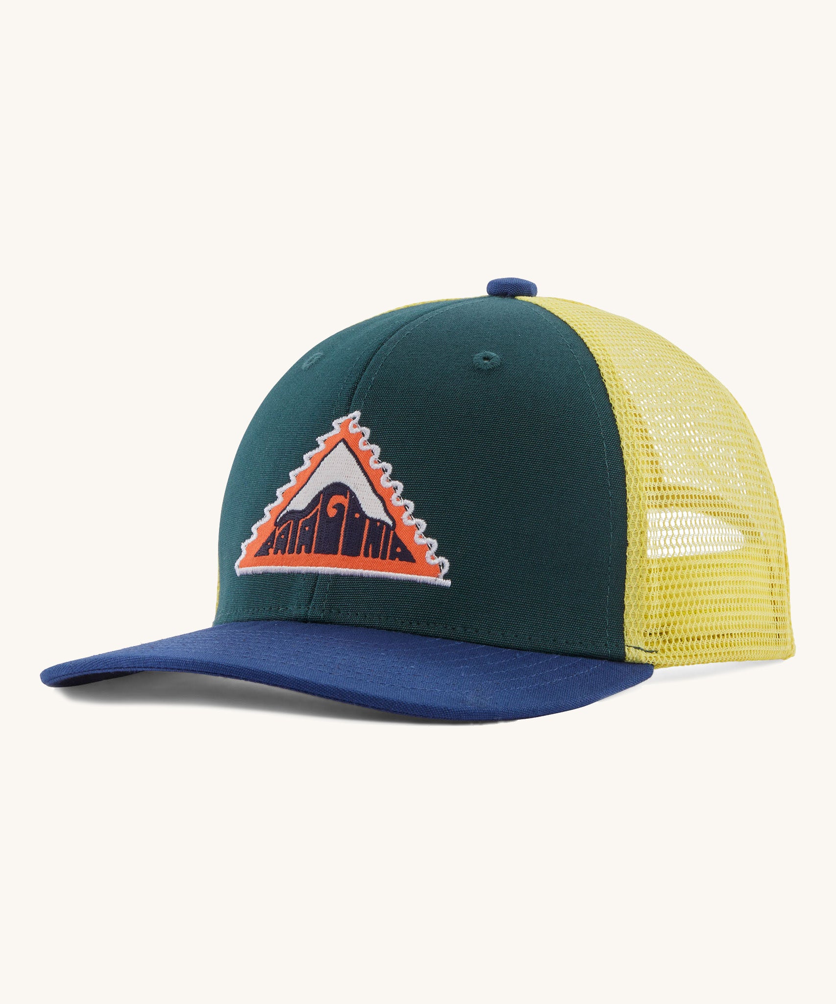 Patagonia kids trucker hat in driftways patch/cascade green. Showing the dark green green front panel, pastel yellow mesh on the back and a dark blue bill. Features a brand patch on the front panel in a shape of a triangle