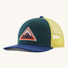 Patagonia kids trucker hat in driftways patch/cascade green. Showing the dark green green front panel, pastel yellow mesh on the back and a dark blue bill. Features a brand patch on the front panel in a shape of a triangle