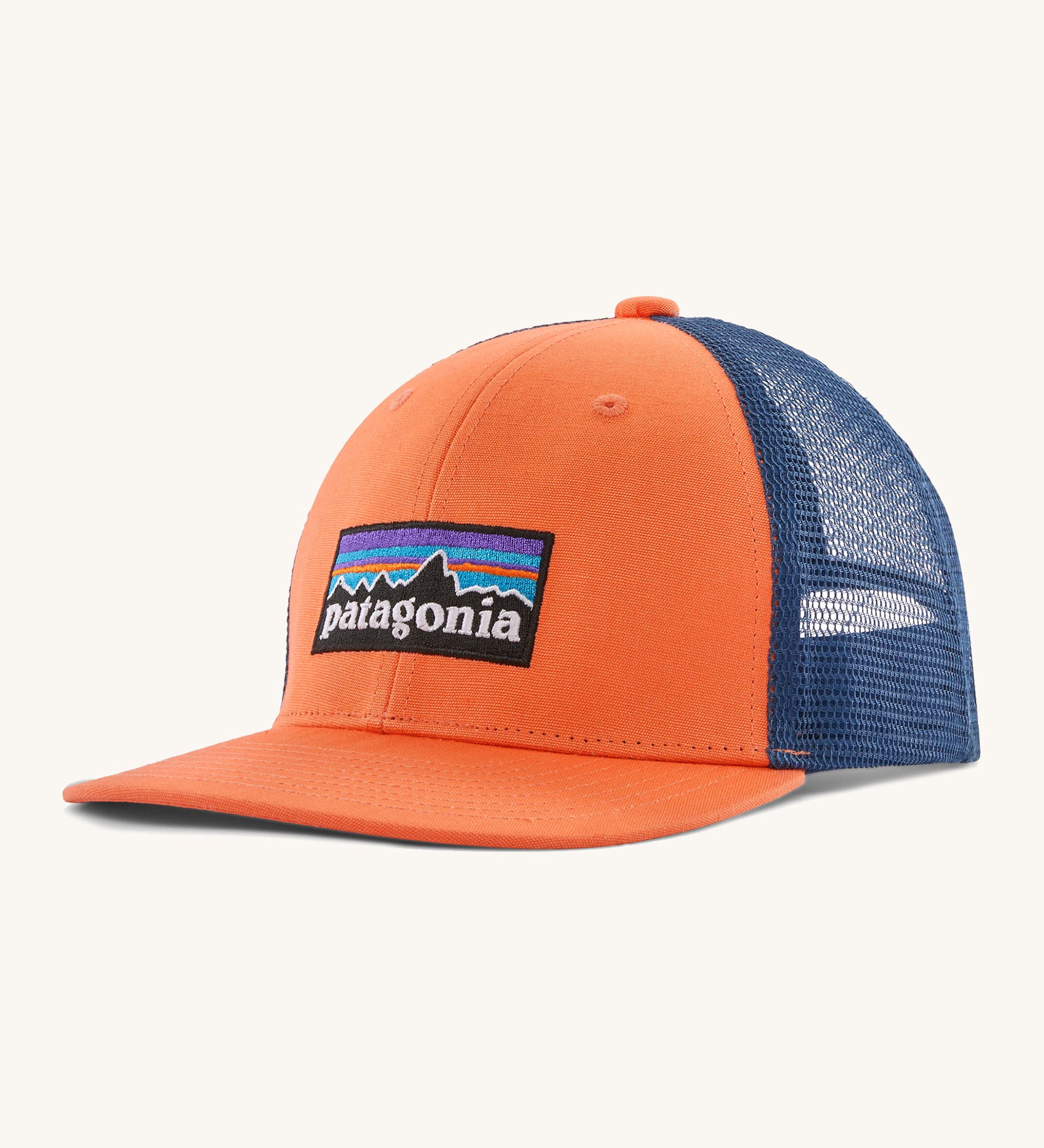 Patagonia kids trucker hat in orange peel . Showing the vibrant orange front panel with matching bill and blue mesh on the back.  Features a brand patch on the front panel.