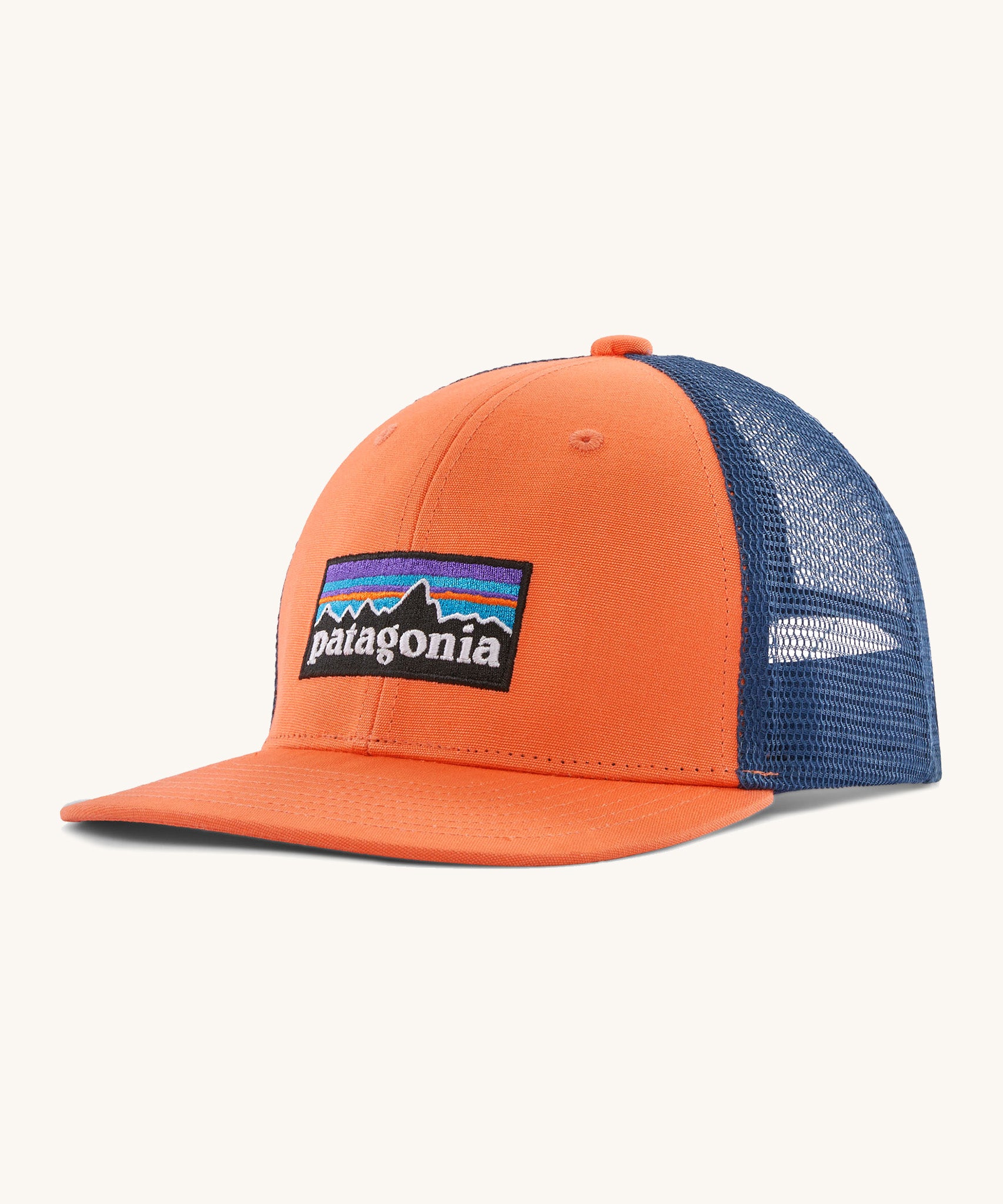 Patagonia kids trucker hat in orange peel . Showing the vibrant orange front panel with matching bill and blue mesh on the back.  Features a brand patch on the front panel.